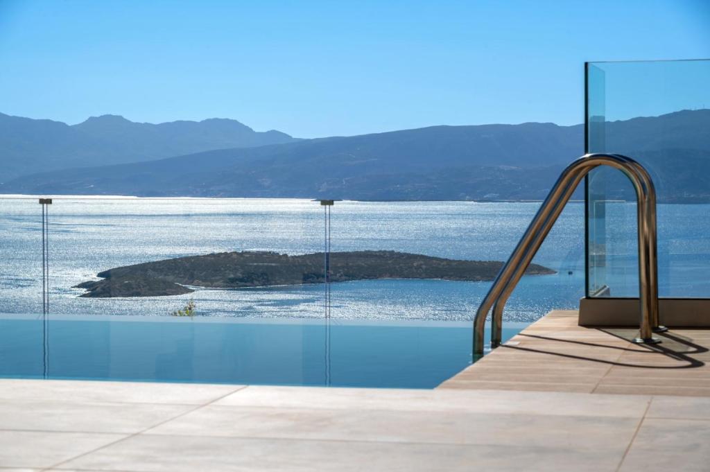 a swimming pool with a view of the water at Majestic View Villas in Agios Nikolaos