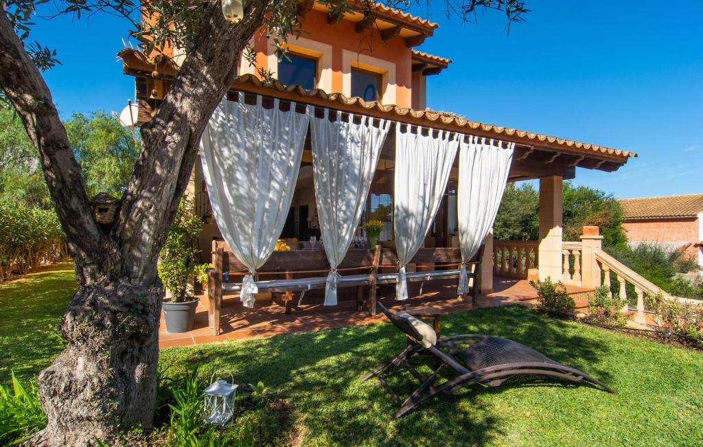 a motorcycle in the grass in front of a house at Estrella De Son Serra in Son Serra de Marina