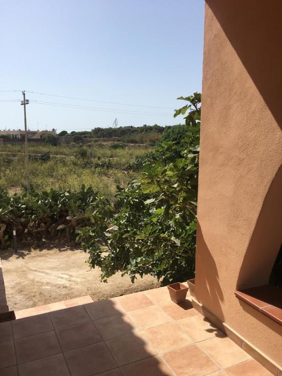 a view from the outside of a house with a tree at Relax e tranquillità a Cala Pisana in Lampedusa