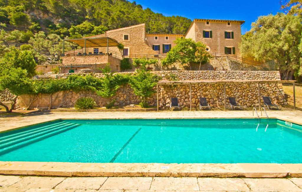 a large swimming pool in front of a house at Biniforani Nou in Bunyola