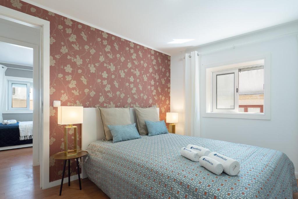 a bedroom with a bed with two pillows on it at Authentic Porto Home by HostWise in Porto