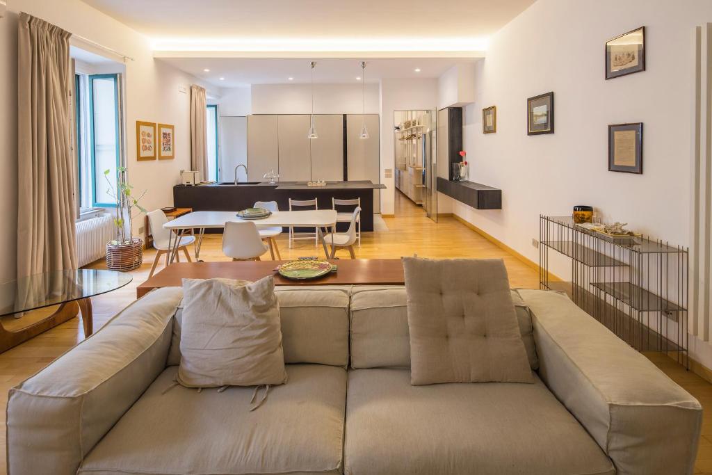 a living room with a couch and a table at Casa Boutique Mareluna - Luxury Apartments by Mareluna Hotel in Salerno