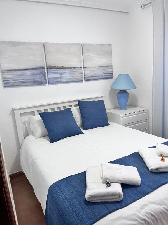 a bedroom with two beds with towels on them at Navarubia in Navacerrada
