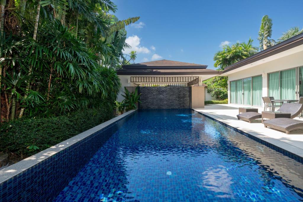 a swimming pool in the backyard of a villa at Coconut villa Phuket Free Airoport Pick up from 7 days in Laguna Phuket