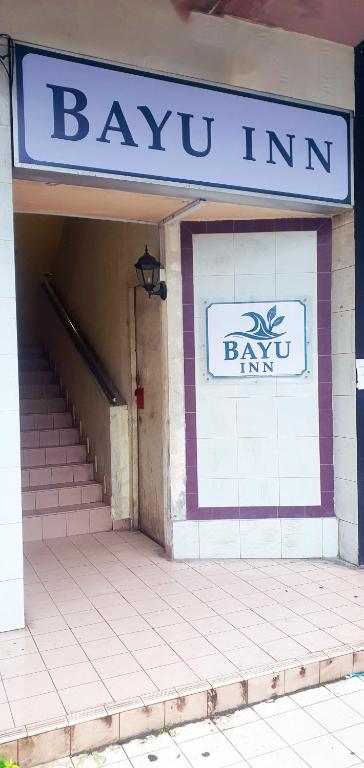 a building with a sign for a bay inn at Bayu Inn in Kota Kinabalu
