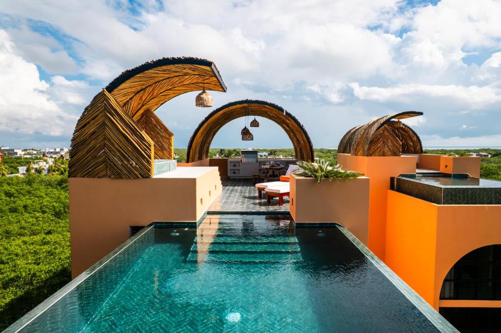 a villa with a swimming pool on top of a building at Coco Lou - Private Villa with Rooftop Pool in Holbox Island