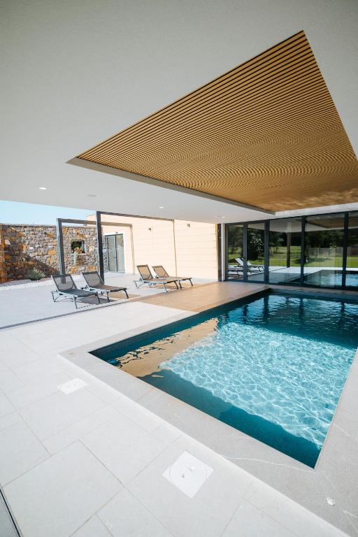a swimming pool in the middle of a house at BRIC Wine & Relax in Vogrsko
