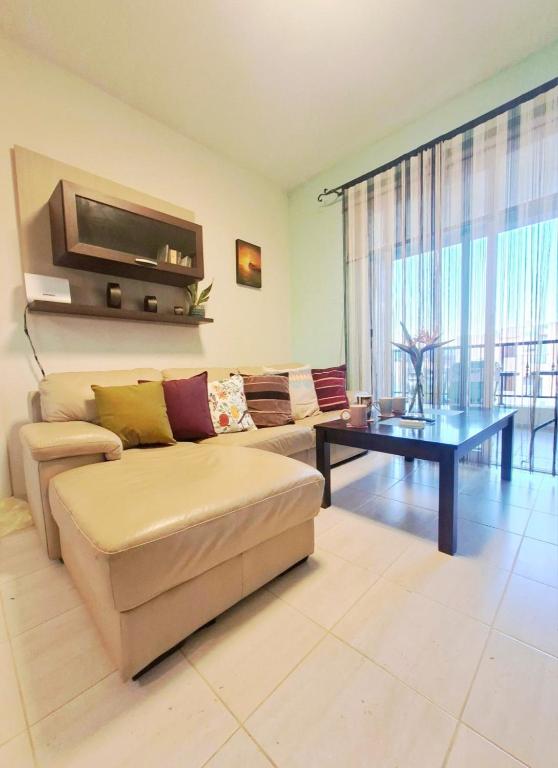 a living room with a couch and a table at Nice relaxing apartment in Mandria, in Mandria
