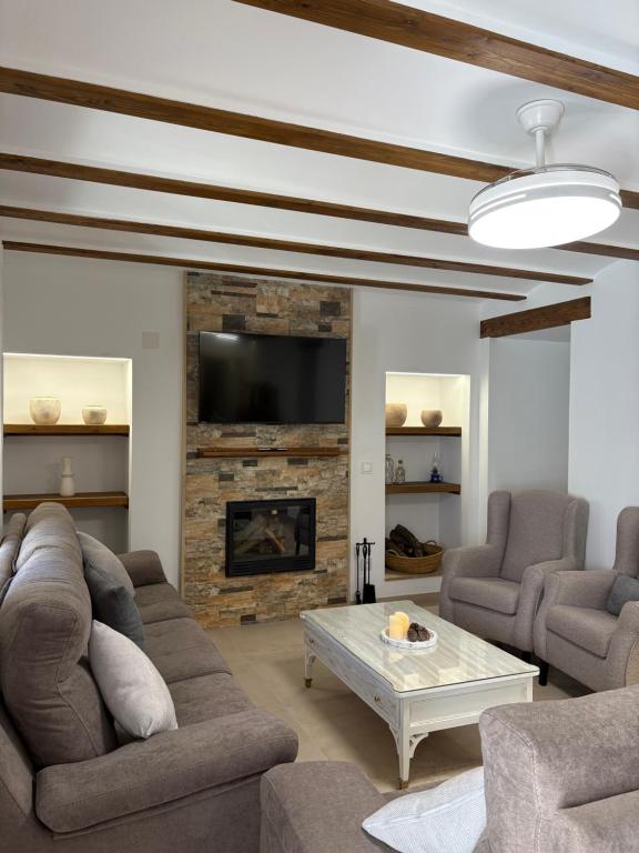 a living room with a couch and a fireplace at La Ermita Casa Rural in Benablón