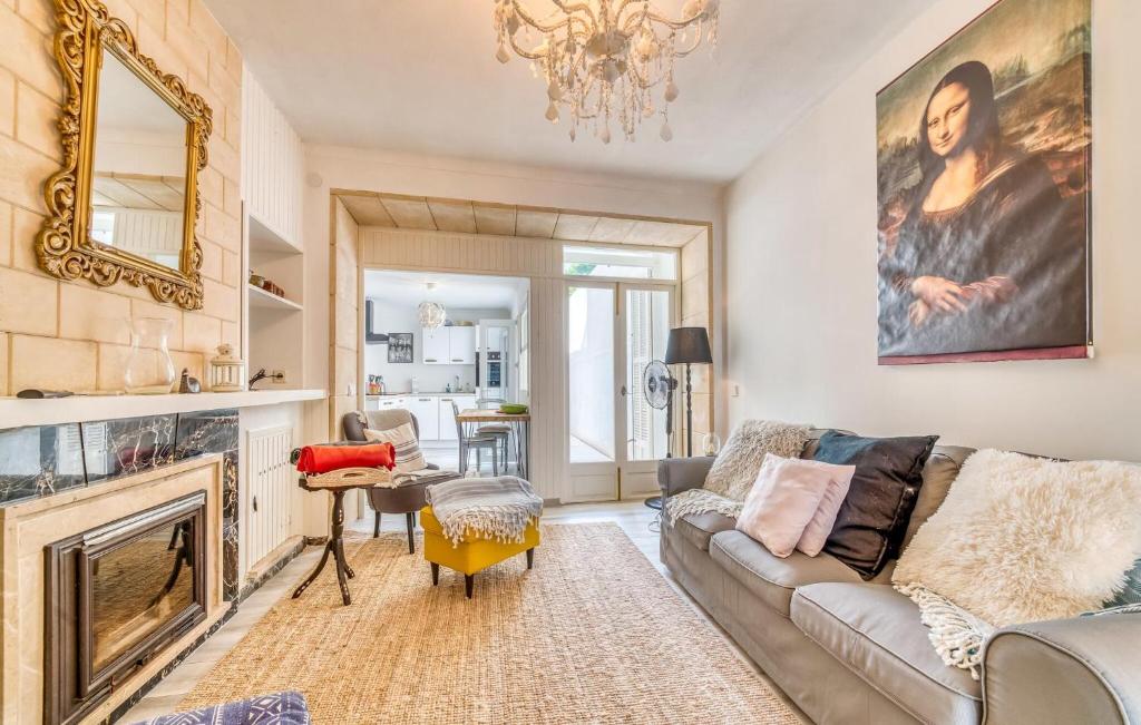 a living room with a couch and a fireplace at Ca Sa Batlessa in Artá
