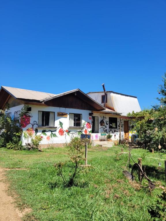 a house with a grass yard in front of it at Casa Berries in Colbún