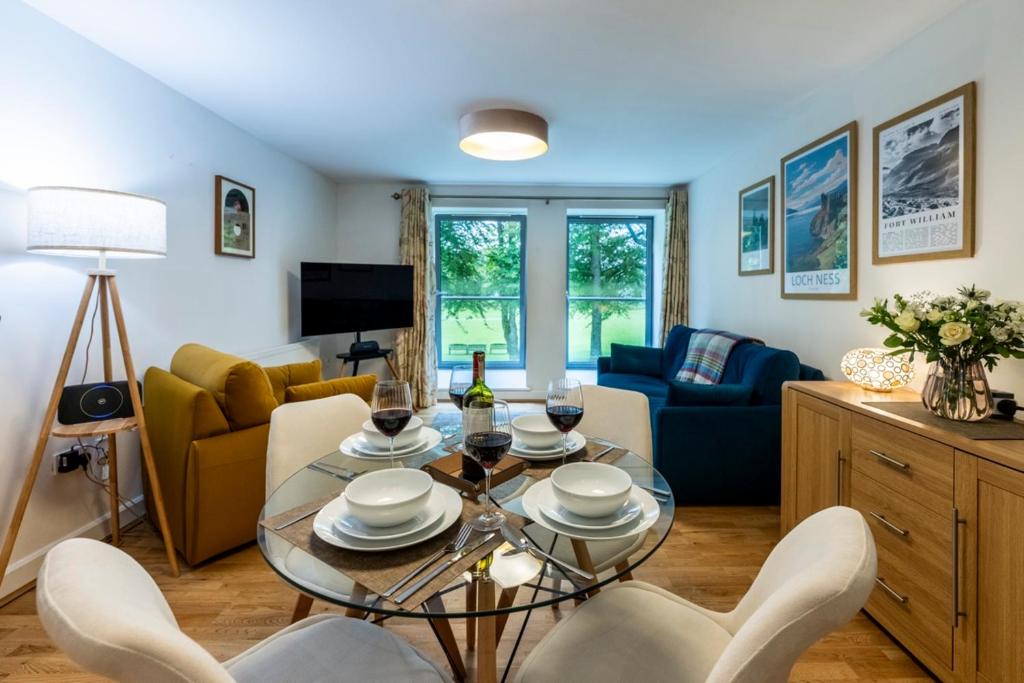 a living room with a table and chairs at Calder apartment Raven Wing in Fort Augustus