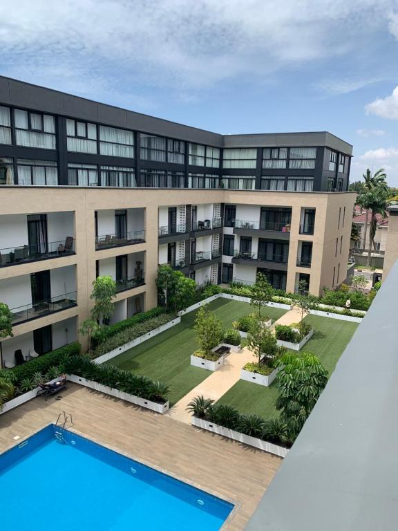 an aerial view of an apartment building with a swimming pool at One Bedroom Premium Luxury Apartments at The Embassy Garderns in Cantonments