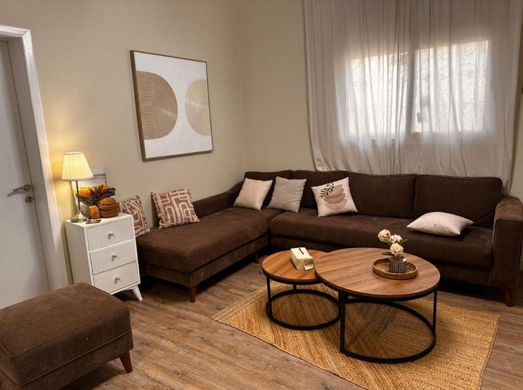 a living room with a couch and a table at Sunset Alula Villa- العلا in Ar Riḩāb