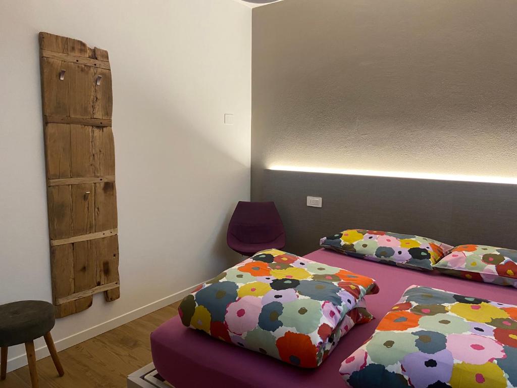 a room with two beds and a table and a chair at CASA VACANZE LA BRENTA in Chiavenna