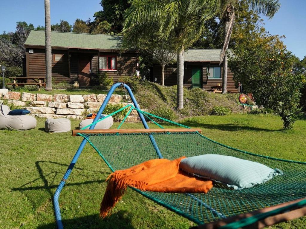 a hammock in a yard in front of a house at Lila in Bet Leẖem HaGelilit