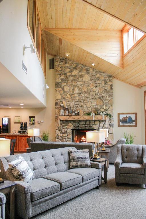 a living room with a couch and a stone wall at Waterbury Inn in Ephraim