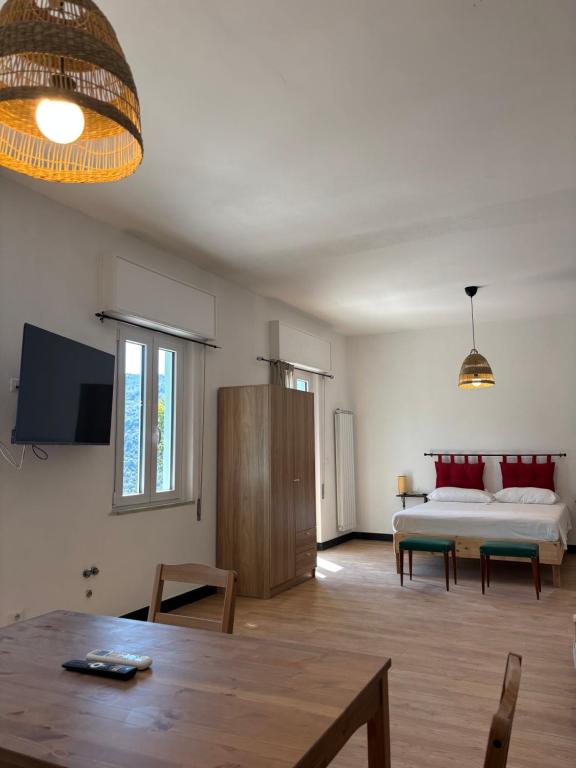 a living room with a bed and a table at Agriturismo Cà da Nonna Rosa in Neirone