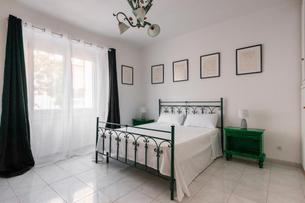 a bedroom with a bed and a window at Downtown flat historic Reggio in Reggio di Calabria