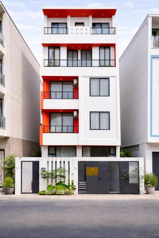 an apartment building with an orange and white facade at Arista - Thanh My Loi in Ho Chi Minh City