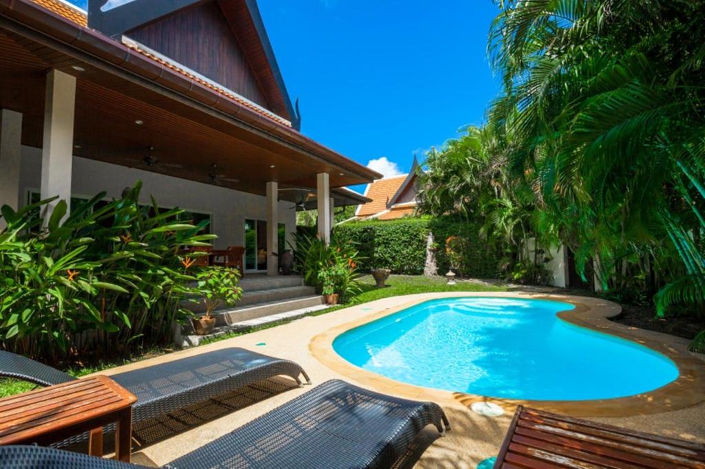 a swimming pool in the backyard of a house at Romanee Villa by G Estate in Rawai Beach