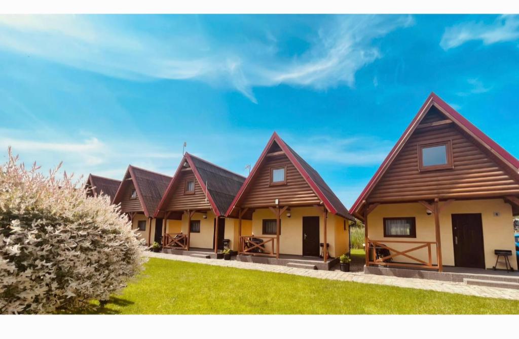 a row of houses with brown roofs at Domki letniskowe Kika in Sarbinowo
