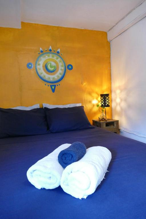 a bedroom with a bed with towels on it at The Bocas Corner in Bocas Town