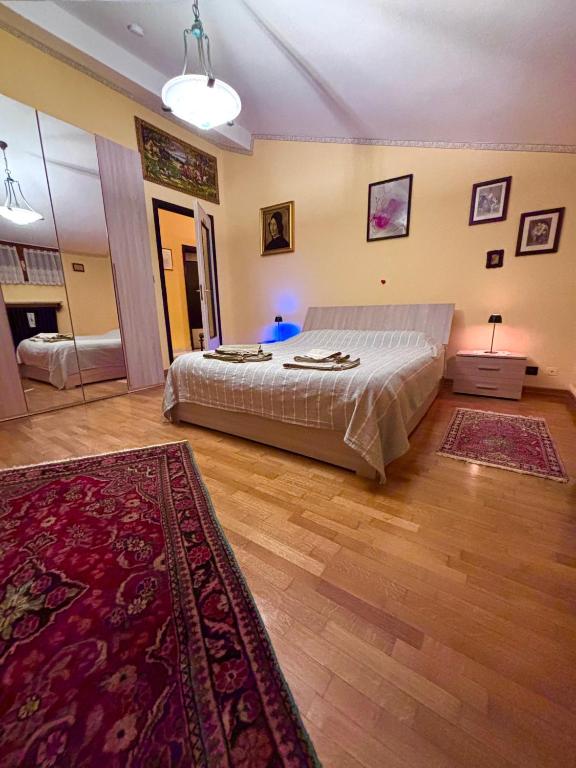 a bedroom with a bed and a rug at Valleverde Apartment in Caraglio