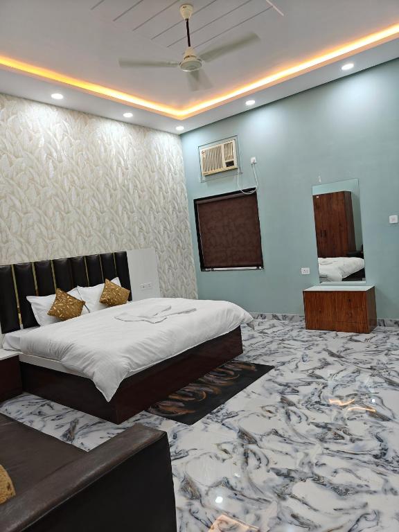 a bedroom with a bed and a projection screen at The KP RESORT in Chīrgaon