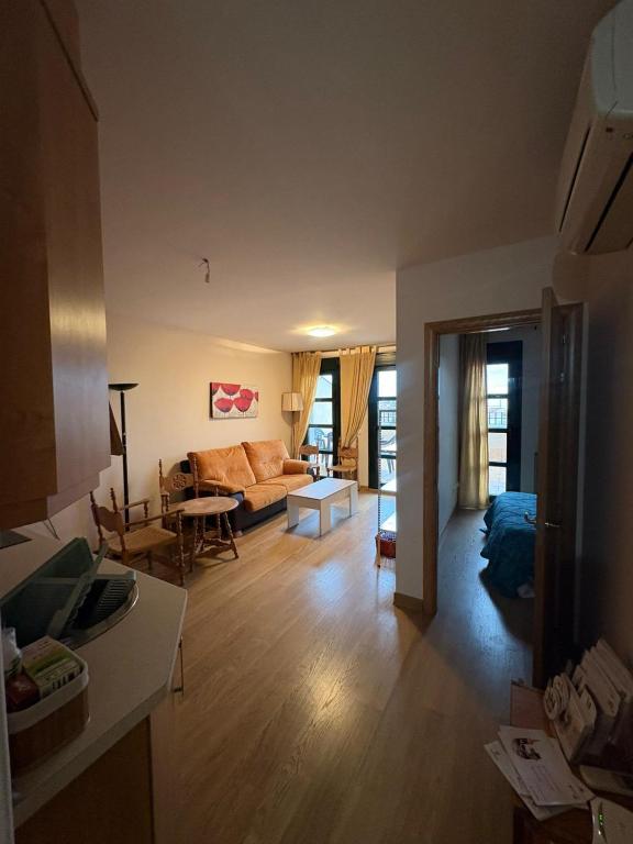 a living room with a couch and a table at Ático Centro in Socuéllamos