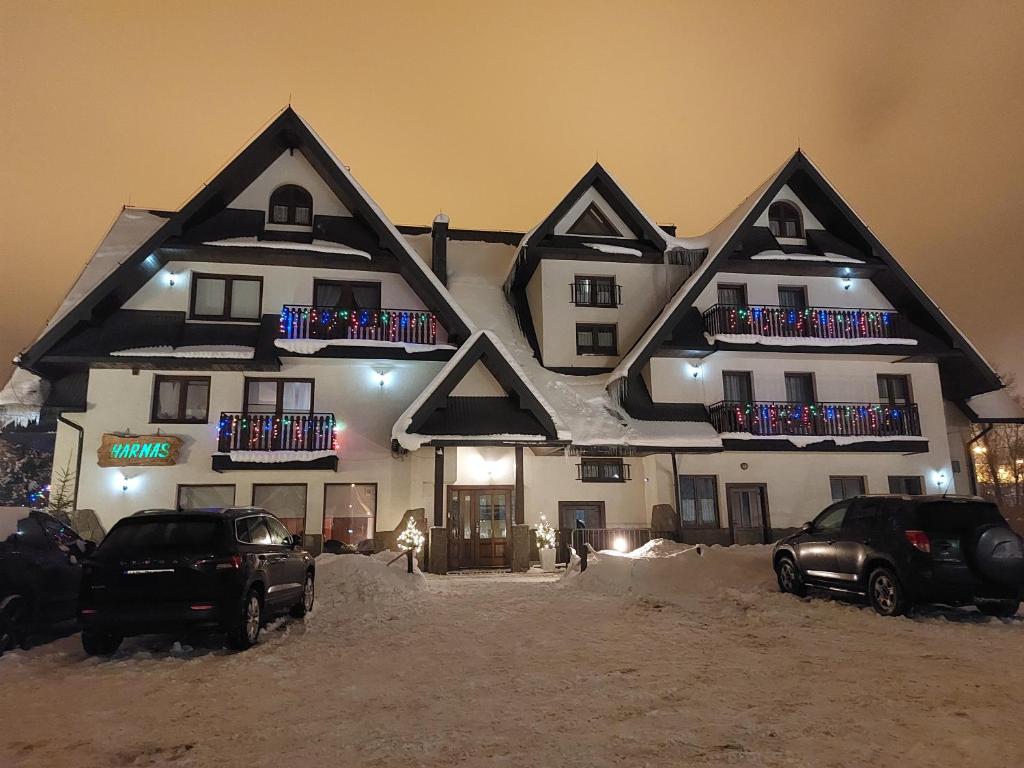 a large house with cars parked in front of it at D.W. Harnaś in Białka Tatrzańska
