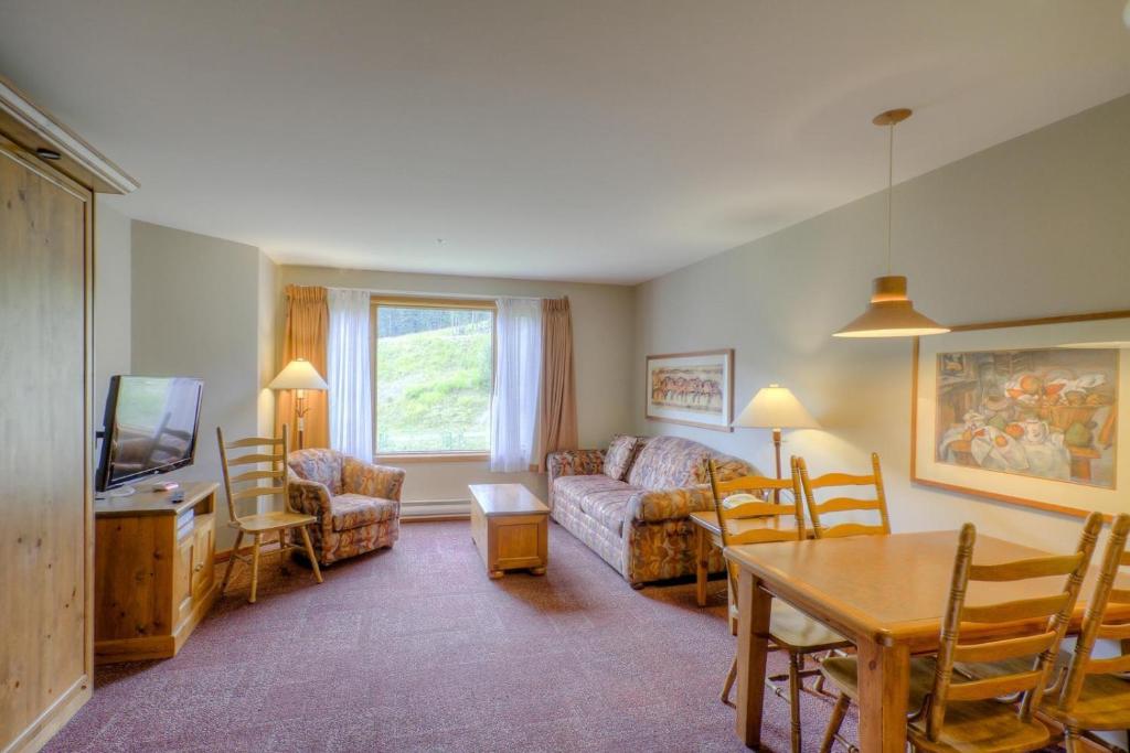 a living room with a couch and a table at Cahilty #122 home in Sun Peaks