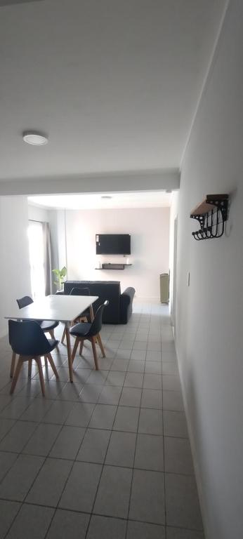a living room with a table and a couch at Dpto del Cerro in Tandil