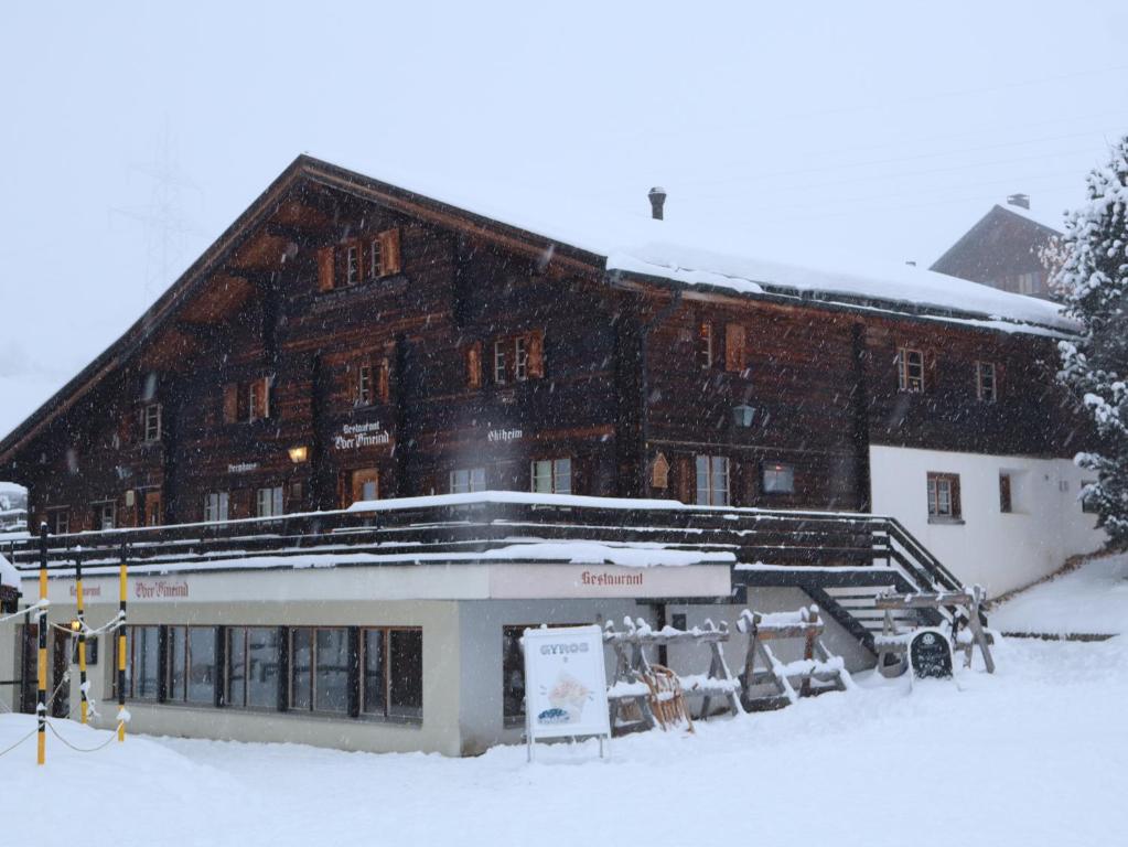 a large building in the snow with snow at Ski- und Berghaus Obergmeind in Tschappina