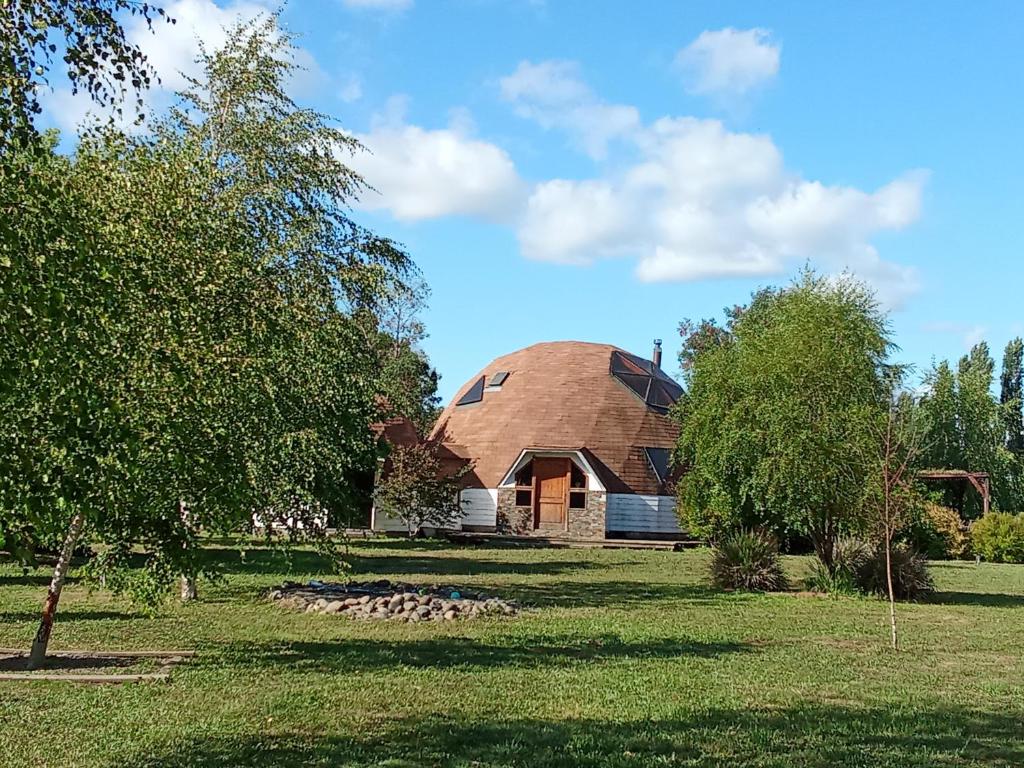 a barn with a dome on top of a field at Domo familiar in Chillán
