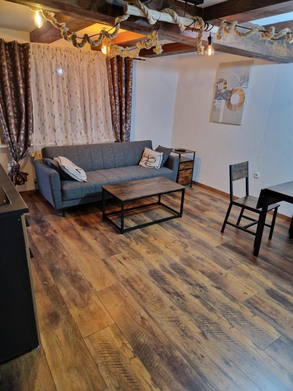 a living room with a couch and a table at Alex Meißner App 2 in Großalmerode