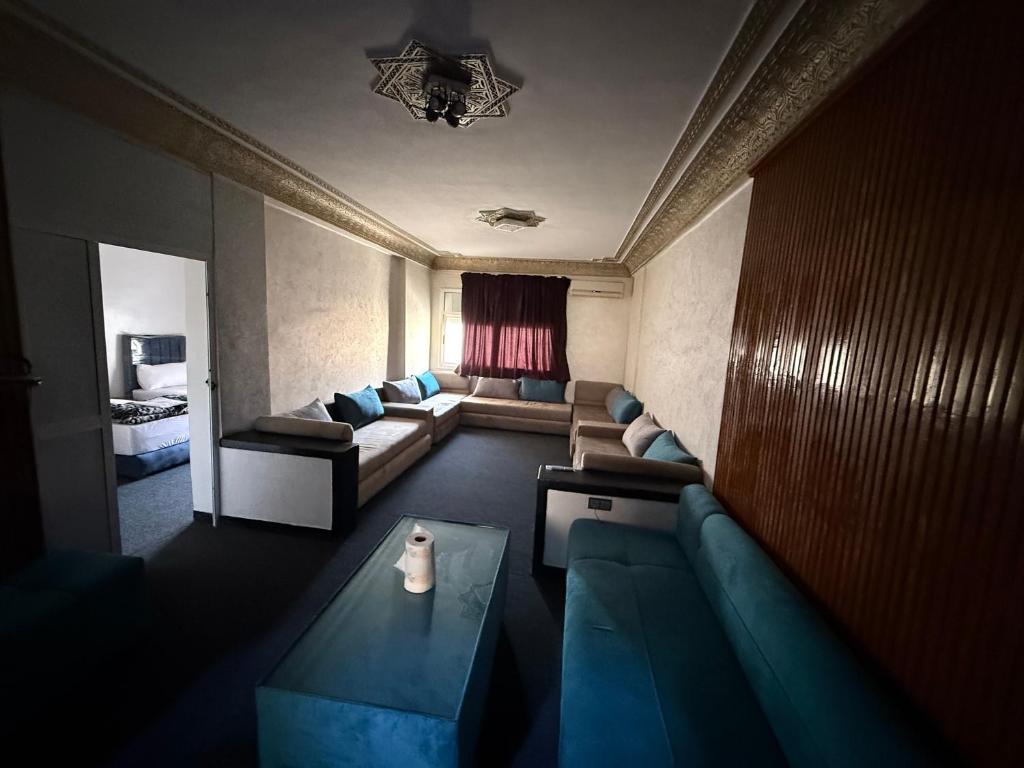 a living room with a couch and a table at Fes Apartment 2 in Fez