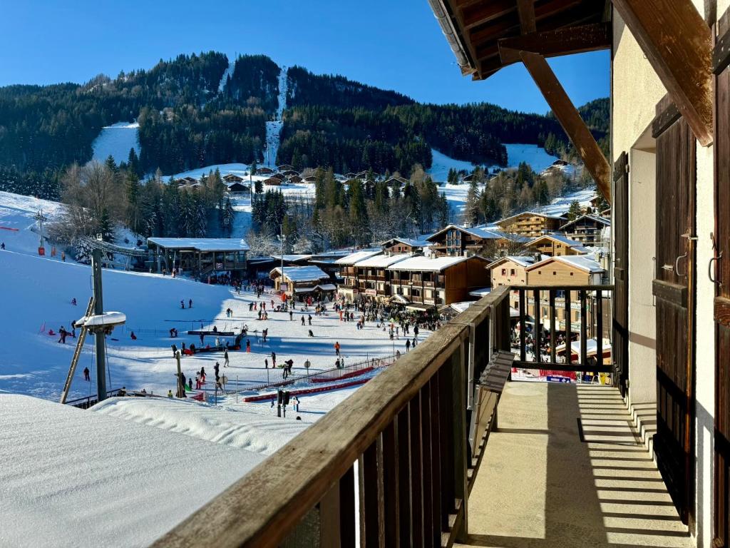 a ski resort with a bunch of people in the snow at La clusaz Centre village , pied des pistes, 42 m2 , balcon sud vue montagne in La Clusaz