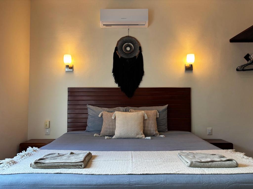 a bedroom with a bed with two towels on it at Tulum Nah in Tulum