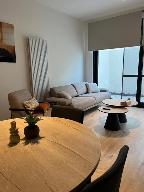 a living room with a table and a couch at FDS Luxe House in Ghent