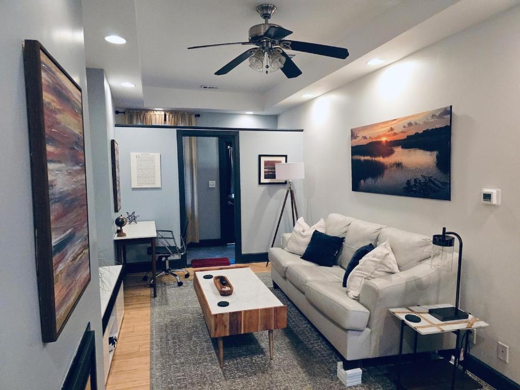 a living room with a white couch and a table at Awesome Downtown Condo with Pool! in Savannah