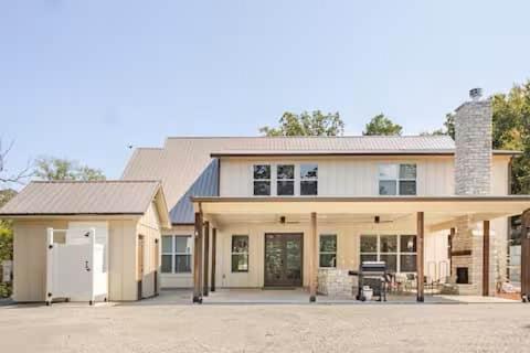 a large white house with a garage at Lakeside Oasis in Longtown