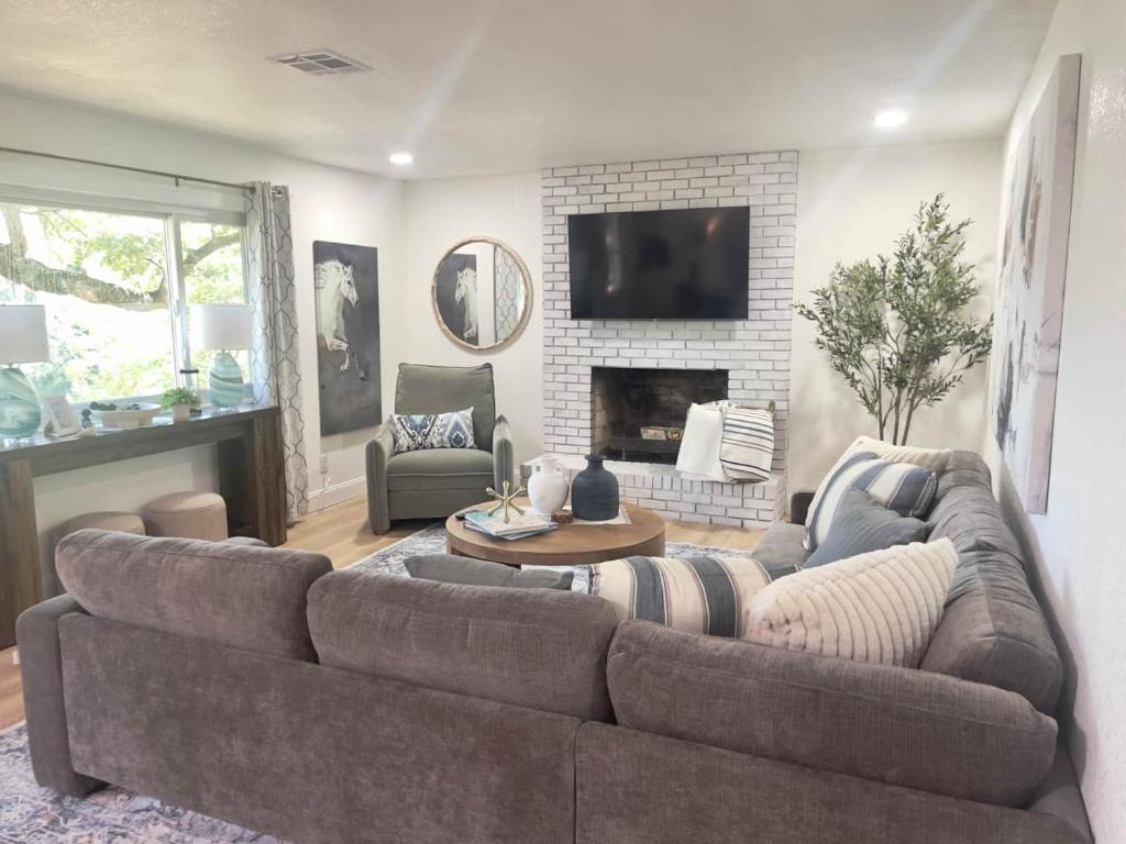 a living room with a couch and a fireplace at Brush Hill Lakehouse in Checotah