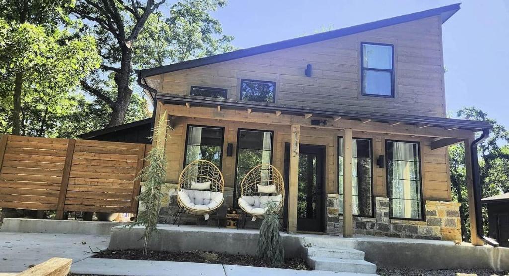 a house with two wicker chairs in front of it at The Pointe Guesthouse in Texanna