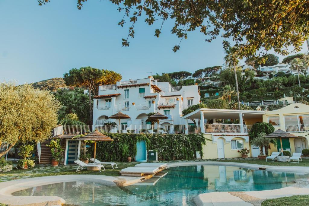 a large house with a pool in front of it at Hotel Continental Mare in Ischia Town