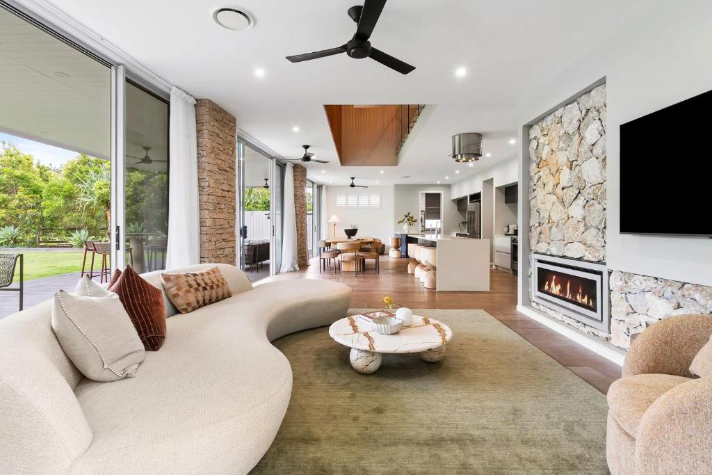 a living room with a couch and a fireplace at Beachfront Wellness Retreat in Kingscliff