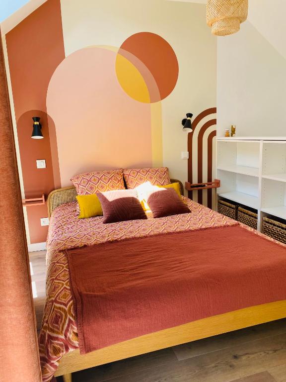a bedroom with a bed with a red bedspread at Duplex house with small terrace in Bayeux