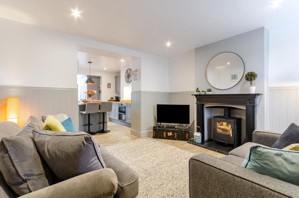 a living room with a couch and a fireplace at 2 Bed in Holt oc-p27287 in Holt