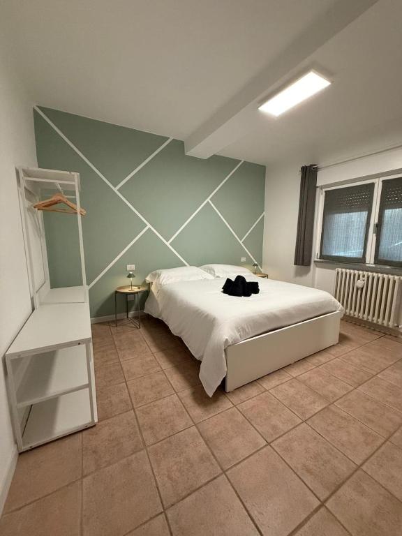 a bedroom with a white bed and a ladder at Cà par durmì in Gravellona Toce