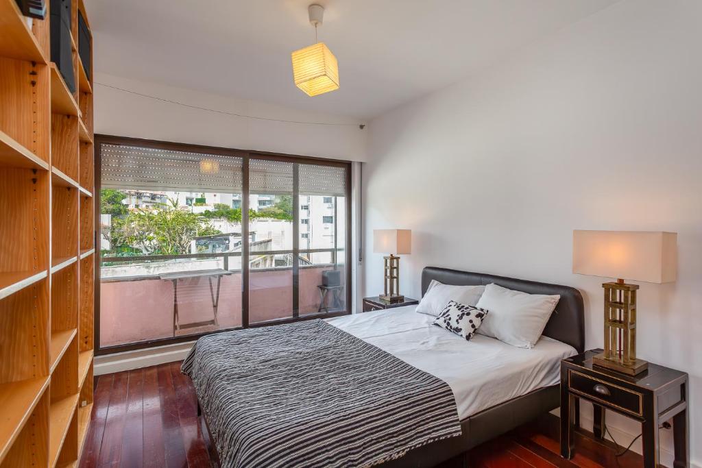 a bedroom with a bed and a large window at Lisbon at Home in Lisbon